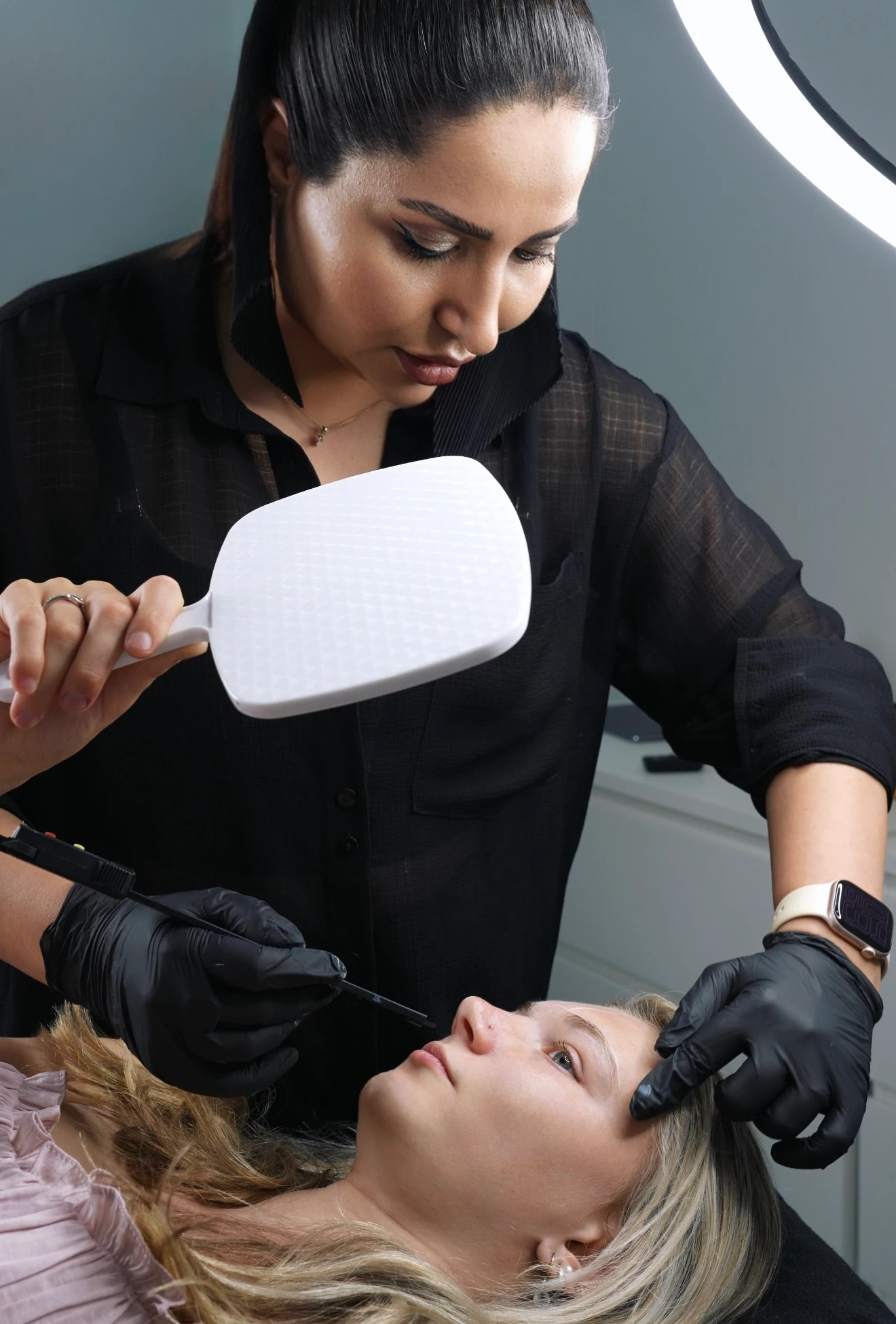 Cosmetic tattoo artist performing a brow treatment at Lilac Beauty in Sydney